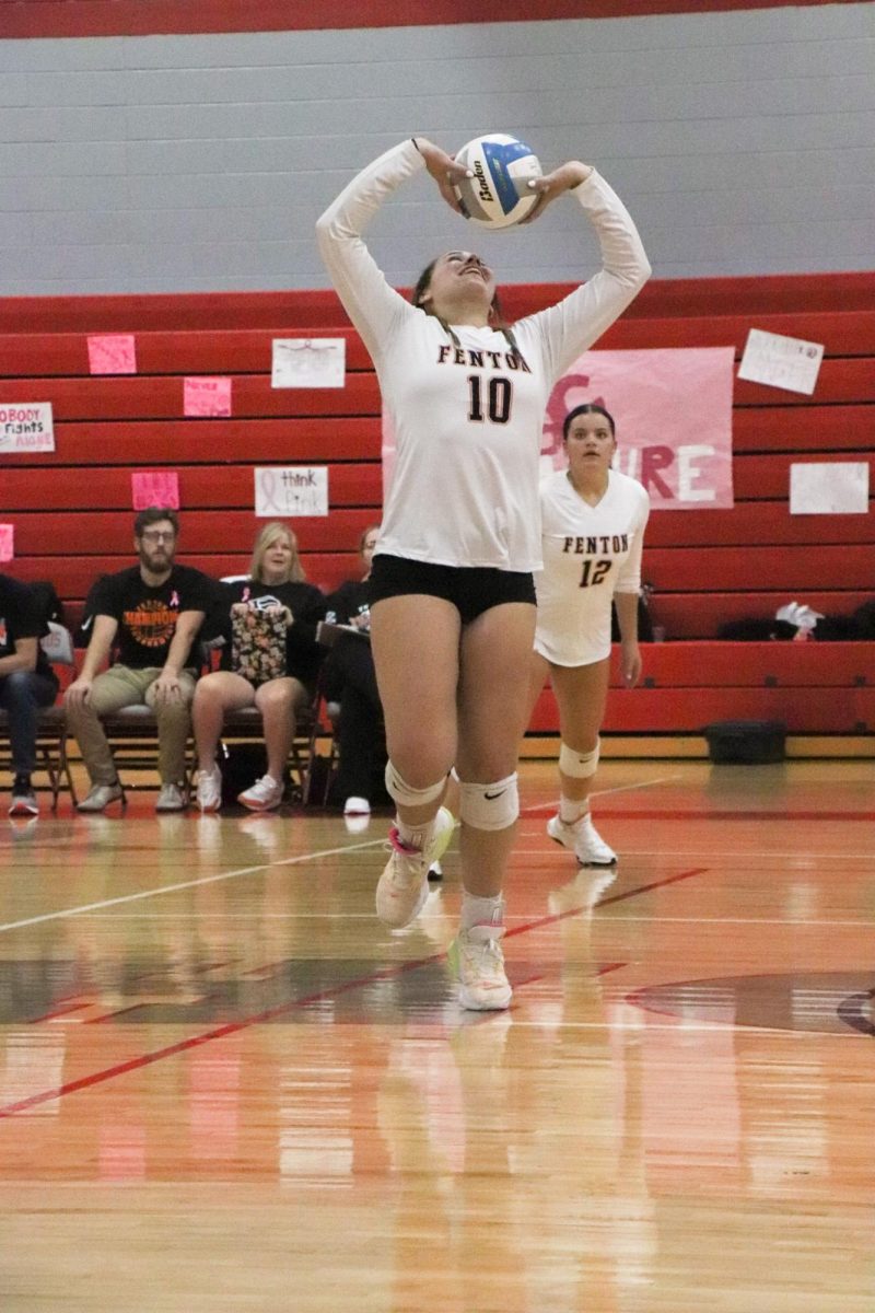 Setting the ball, senior Abby Gonzales attempts to make a pass to her teammate. On Oct. 2, the Fenton varsity volleyball team played Holly and won 3-0.