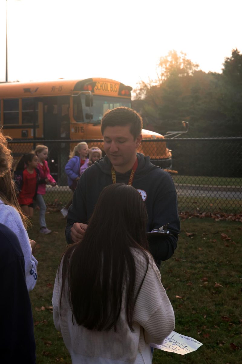 Explaining directions, teacher Nicolaus Jeffrey tells the E.C.O. club students which elementary kids they will be working with. On Oct. 23, the FHS E.C.O. club hosted a pond day for the elementary schools. 