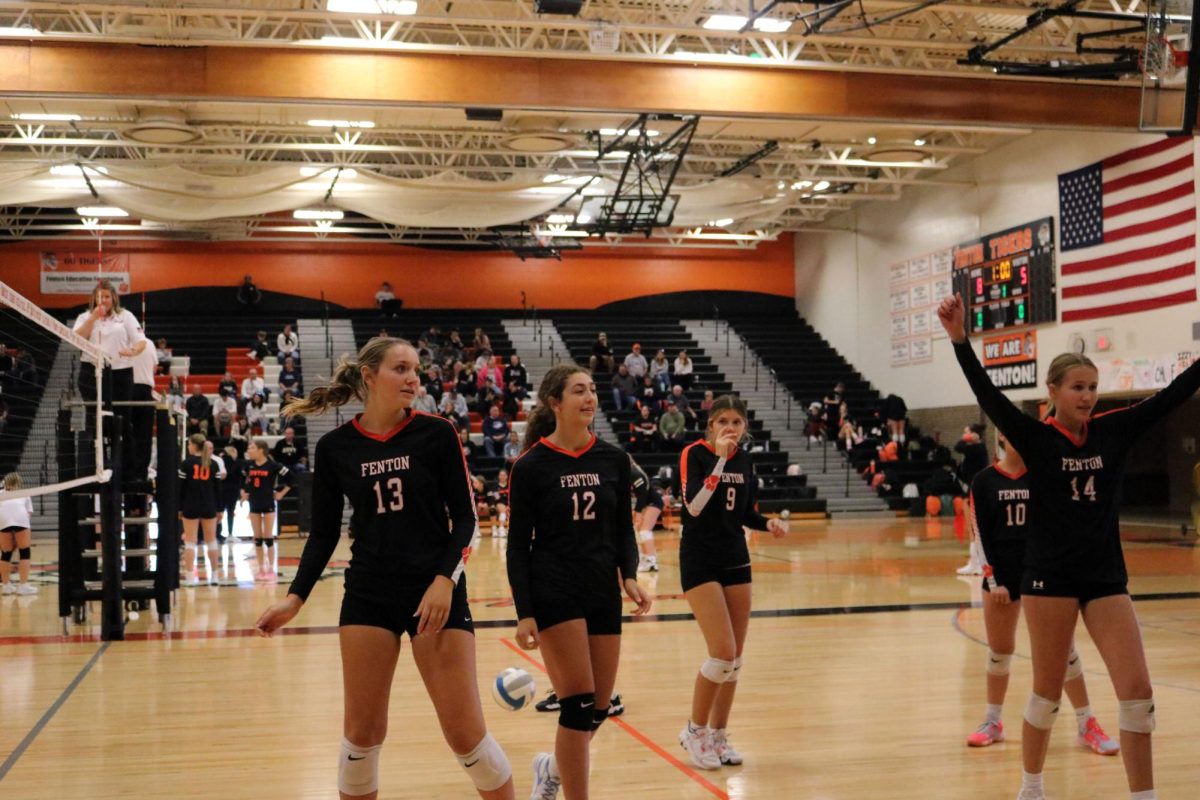 Celebrating the freshman volleyball team walk off the court after winning their game.  On Oct. 9, the freshmen went against Kearsley winning all three sets.
