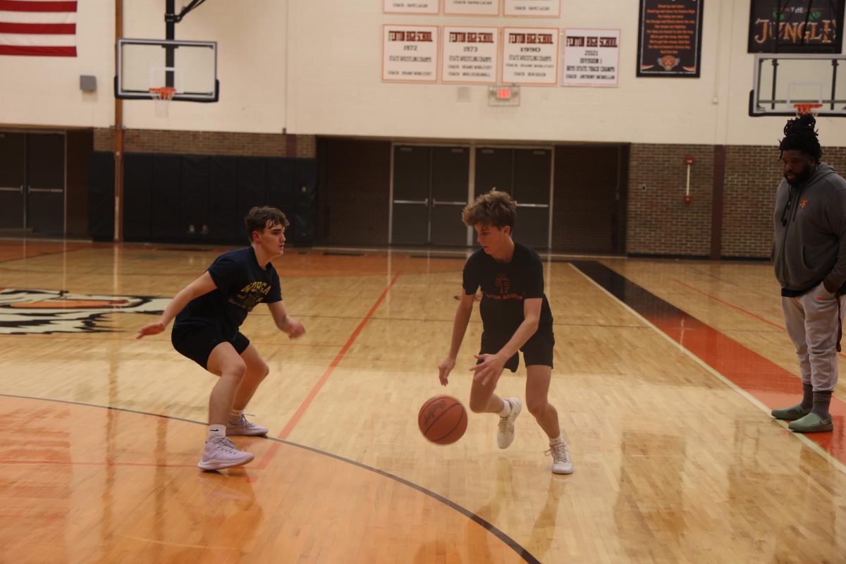 Dribbling, sophomore Lewis Roberts tries to get past. On Nov. 12, the boys basketball team held tryouts. 