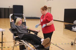 Sitting, senior Maddie Knight donates blood. On Nov. 15, the National Honors Society hosted a blood drive for students willing participate. 