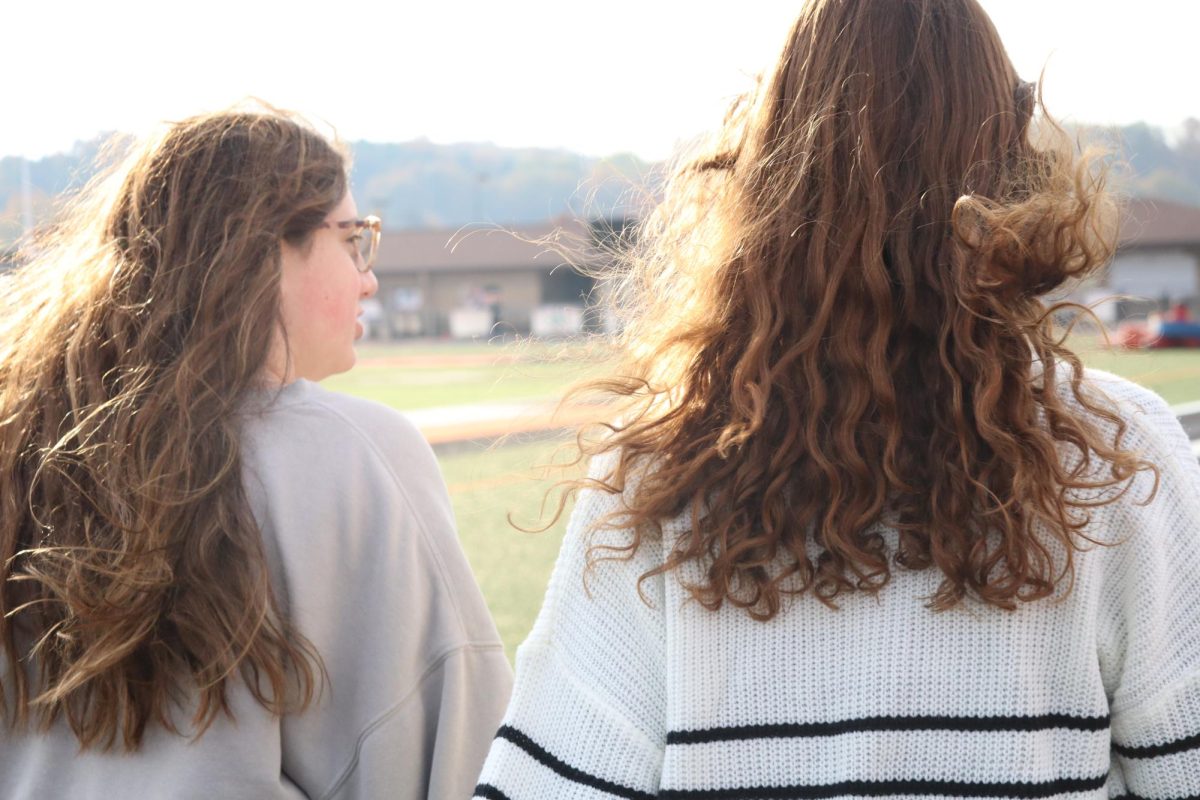 Walking, Juniors Hayley Jensen and Haven Selby raise awareness for Alzheimer's. On Oct, 29 students at Fenton High paid 5 dollars to walk around the track during SRT. 