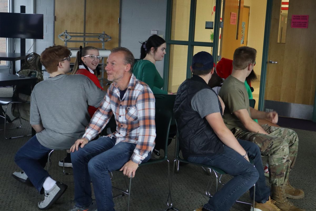 Laughing, senior Lillian Moore participates in a game of musical chairs. On Oct. 31, the students for Christ group met after school in the project room. 
