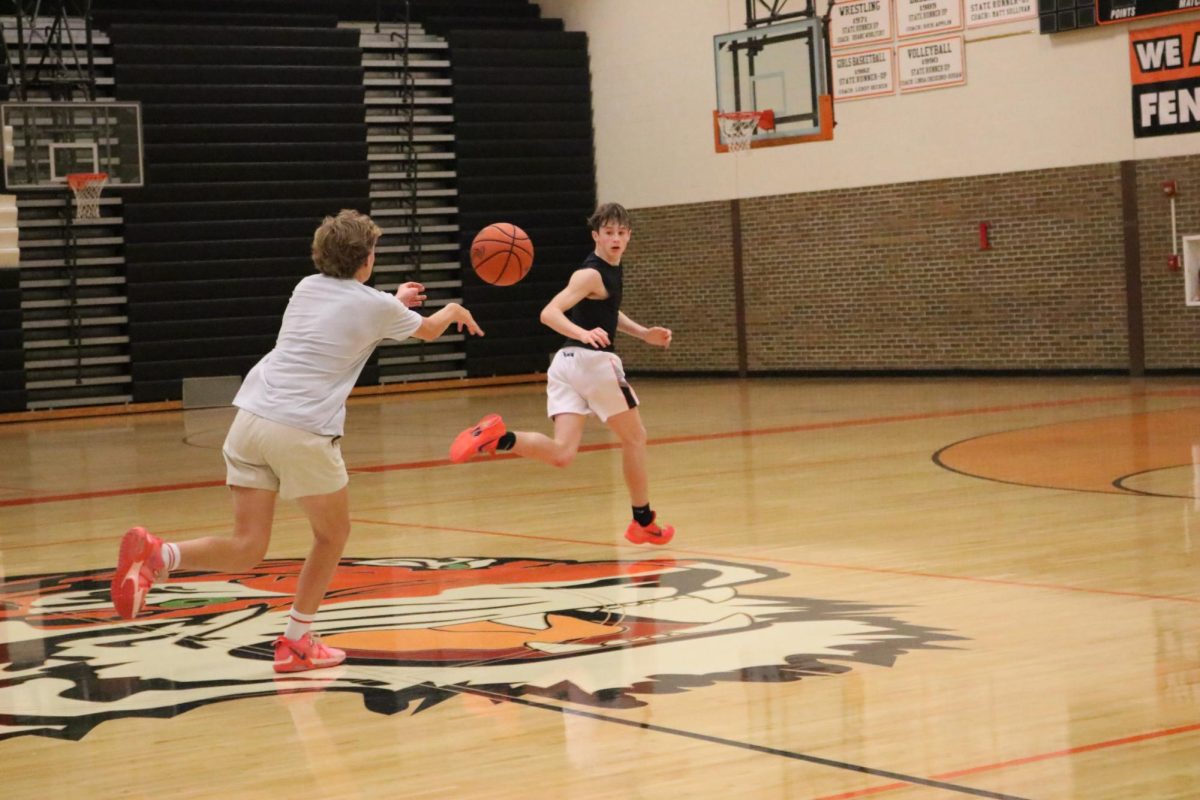 Running, sophomore Larkin LaFontaine is receiving a pass from James MacCaughan. On Nov. 14, the boys basketball team held there third day of tryouts. 