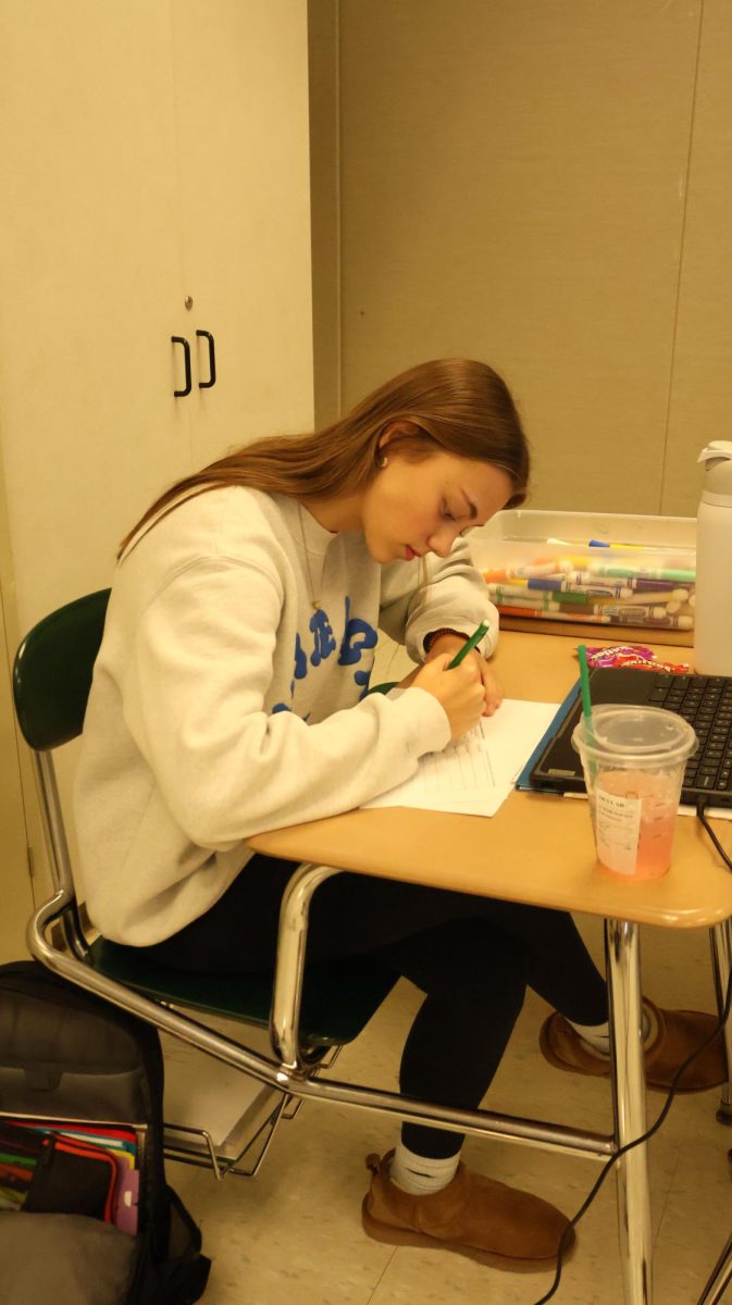 Casting her vote, junior Skylar Lutz fills out her voting form with future presidential candidates. On Nov. 5, students participated in a mock election in SRT.