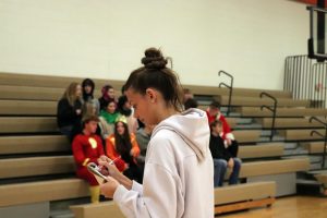 Writing senior Adrianna Ayre perapres list for club photos. On Nov. 14, Fenton High School clubs get their photo taken for the yearbook. 