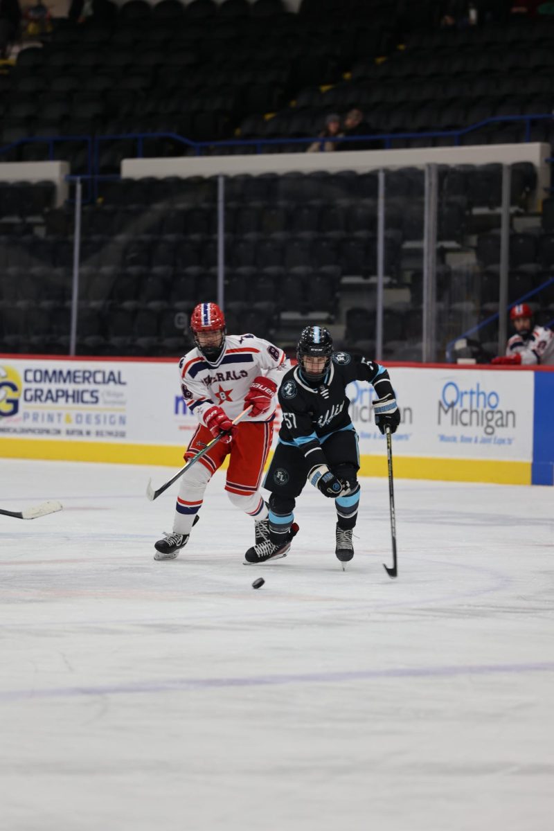 Skating, sophomore Trent Rockman goes towards the puck. On Dec. 11, the Griffins played Genesee Generals and lost 3-4. 