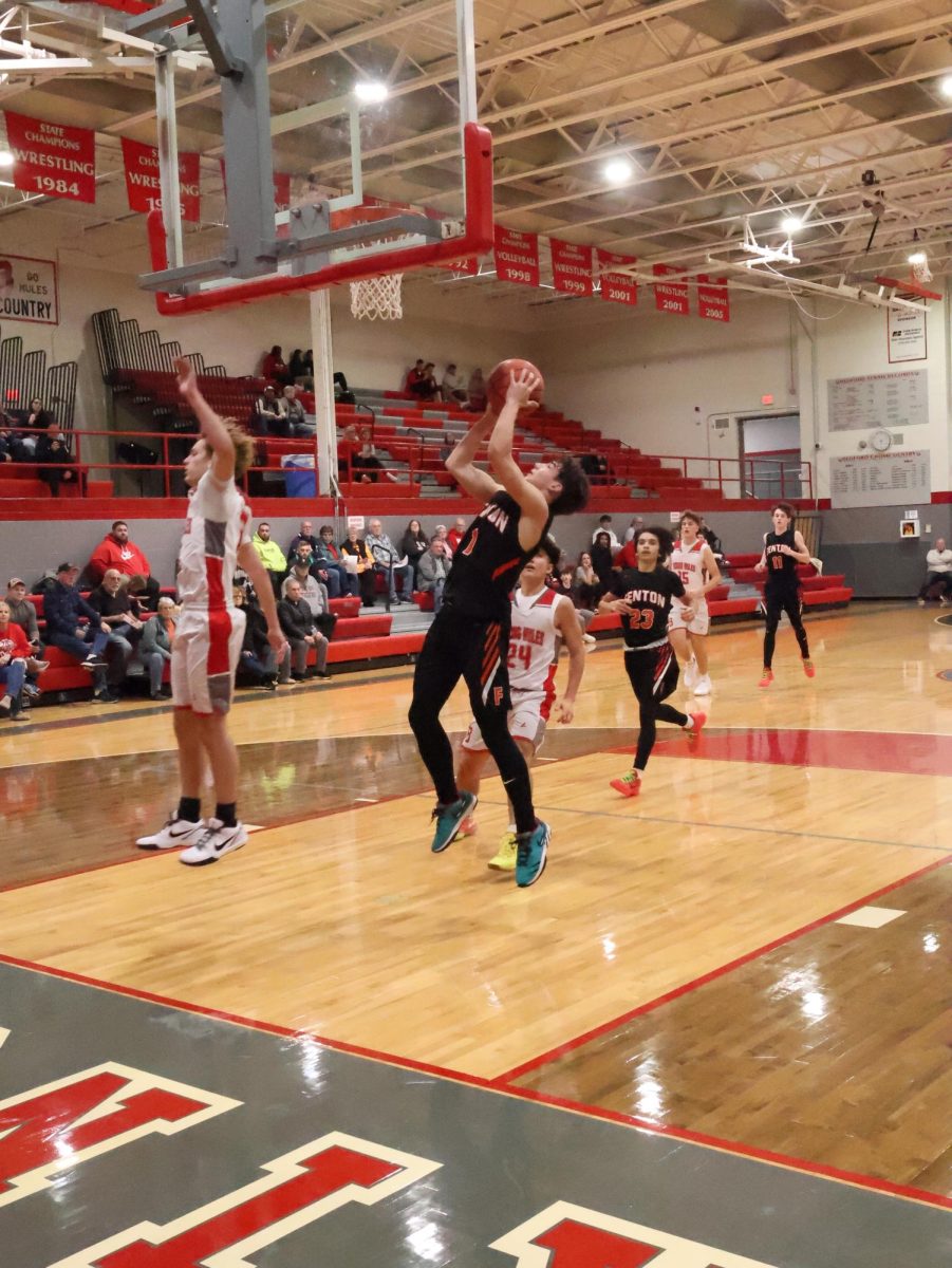 Jumping, sophomore Landry LaFontaine scores a basket. On Nov. 26, the boys jv basketball team went up against Bedford High winning 39-34. 