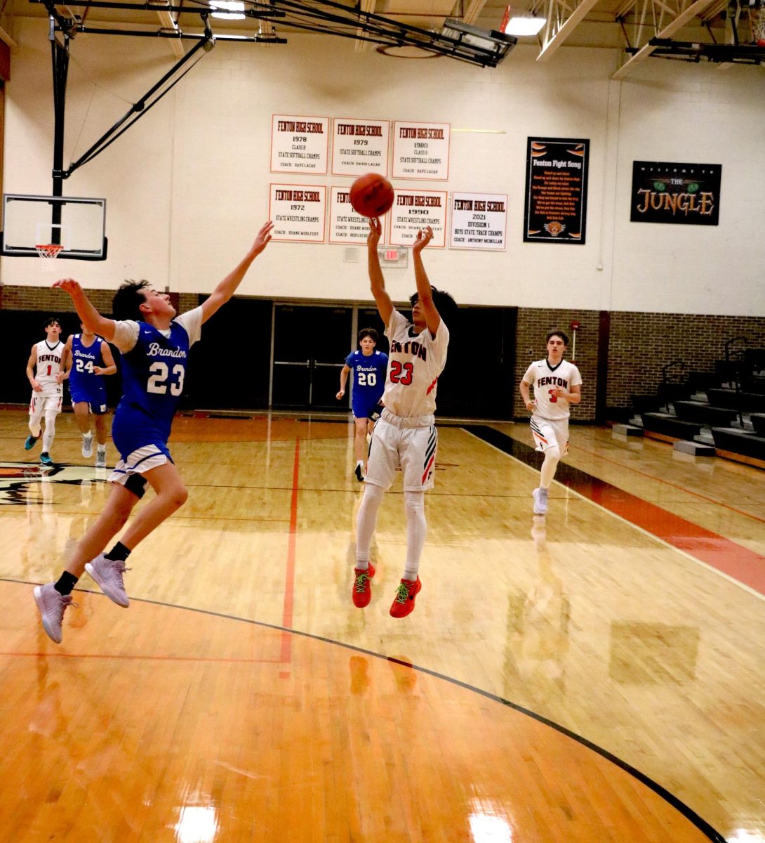 Shooting, sophomore Madden Shaman puts up a three pointer. On Dec. 3, the Fenton JV basketball team went up against Bedford winning 80-18.