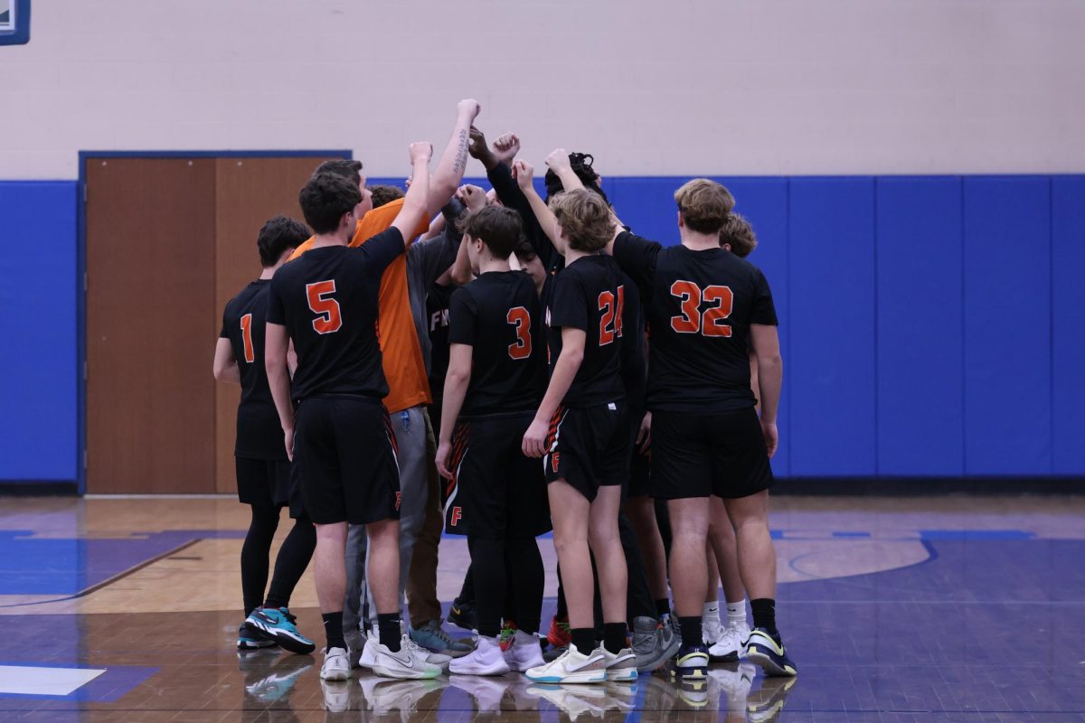 Huddling, the Tigers prepare to go back out onto the court. On Dec. 9, the JV boys basketball team went up against Lake Fenton High and won. 