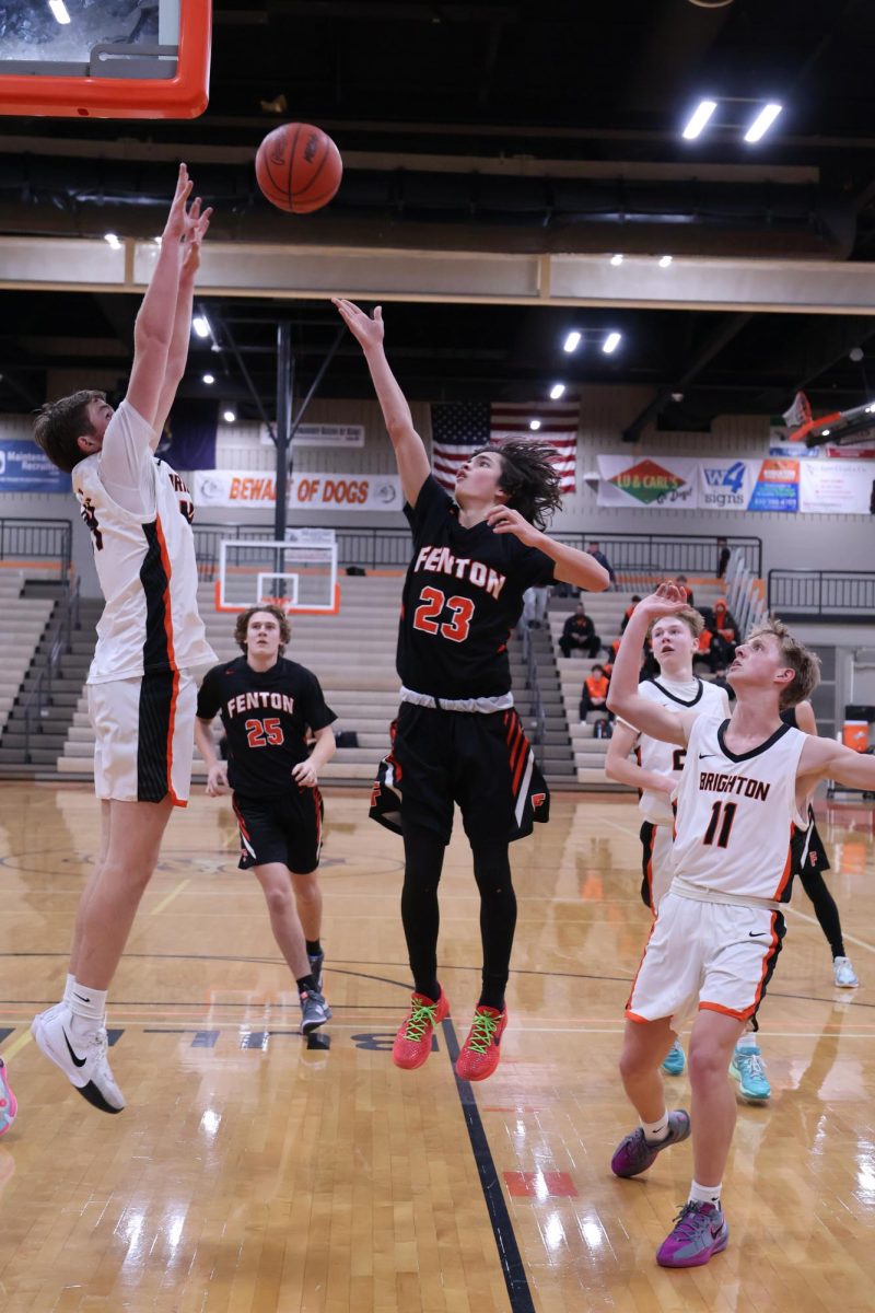 Shooting, sophomore Madden Shaman attempts to make a basket. On Dec. 16, the Fenton Tigers went up against Brighton High and lost.  