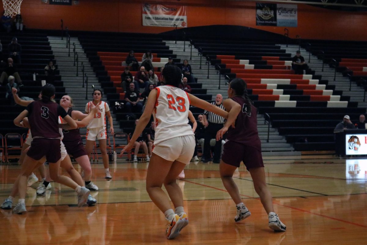 Blocking, #23 senior Ava Slezinski defends her side of the court.  On Dec. 10, Fenton girls varsity basketball lost against Milford.  