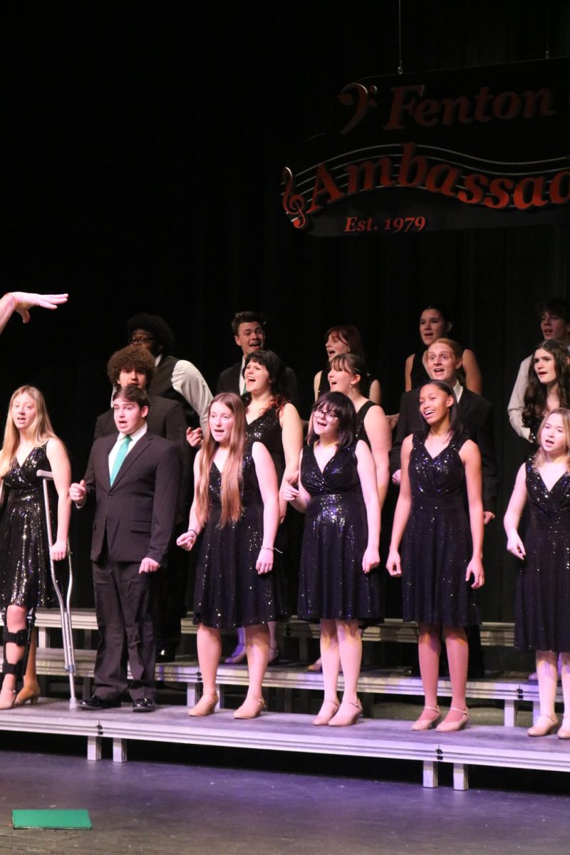 Singing, senior Zoe Plunkett and junior Kierstyn Rutley rehearses for ambassadors. On Dec. 6, Ambassador's director Brad Wright held a rehearsal in the auditorium for their upcoming concert on Dec. 12.