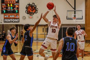 Shooting, Junior Landon Becker attempts a two point shot. On Dec. 3, the Fenton varsity tigers took down Brandon 77-46.