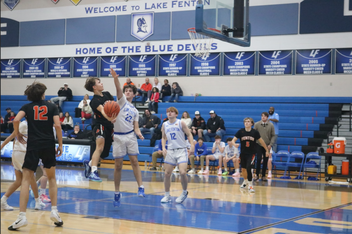 Leaping to the basket, freshman Alec Mock goes for the shot. On Dec. 9, the freshman boys basketball team played against Lake Fenton and lost.