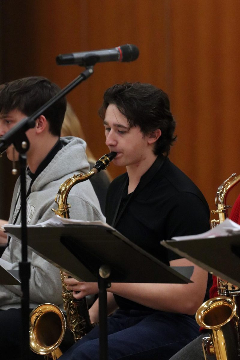 Playing the saxophone, junior Dominic Maini performs for the school. On Dec. 17, the FHS band and choir came together for a holiday concert held during SRT. 