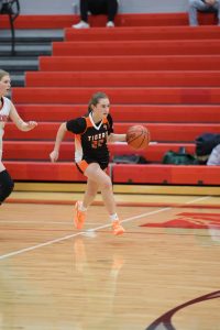 Dribbling the ball, freshman Alexis Mays runs up the court in attempt to score. On Dec. 13, the JV basketball team played Holly and won.