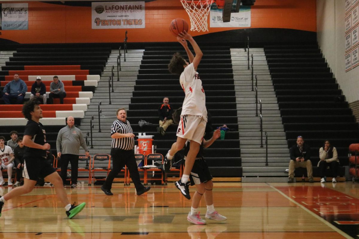 Jumping, freshman Brady Pearson is going for the lay-up. On Jan. 9, the freshman boys basketball team played Fenton's rivals, Linden and won. 