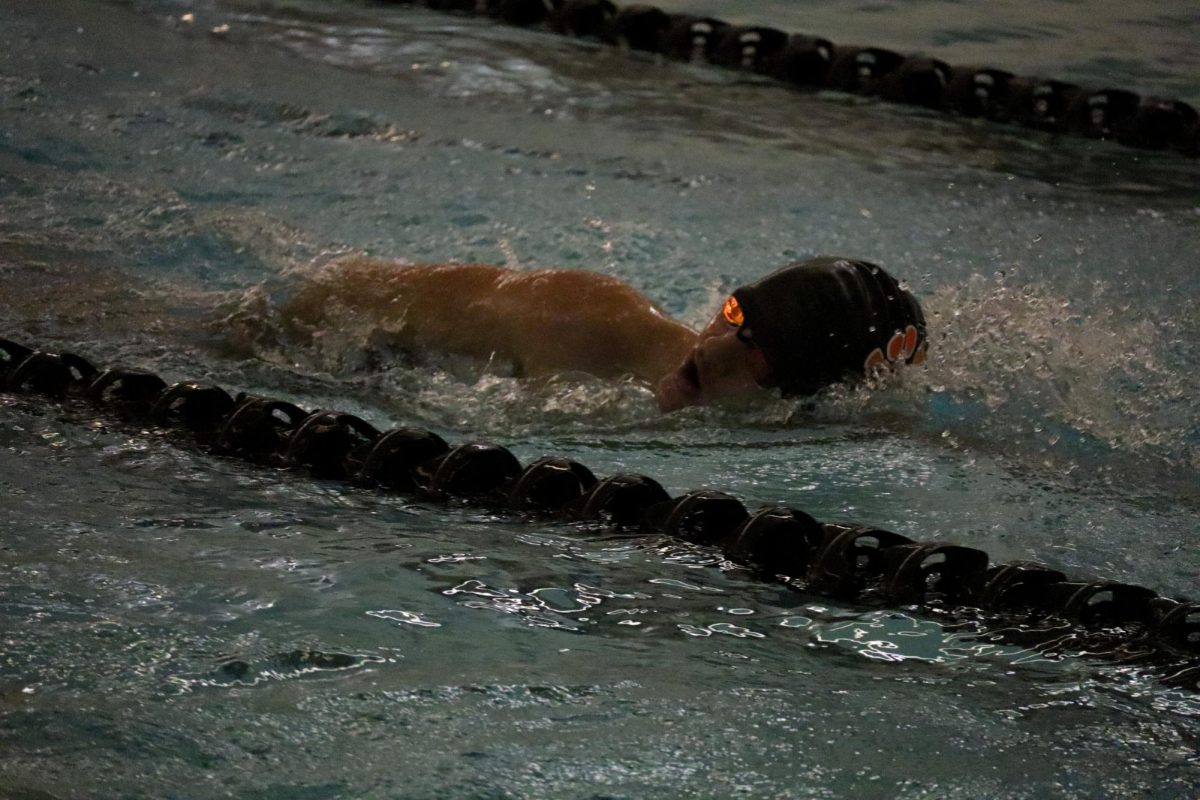 Swimming, sophomore Beckham Welsh swims his lane doing the freestyle stroke. On Dec. 11, the varsity boy's swim team practiced for their upcoming swim meet. 