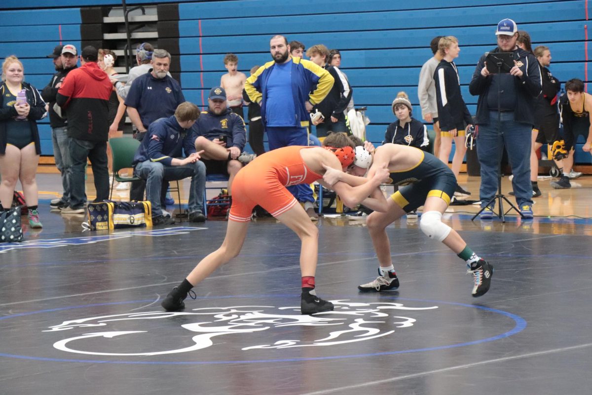 Going head to head junior Aiden Velsey wrestles his opponent. On Dec. 18, Fenton competed against Owasso Aiden came first in his bracket. 