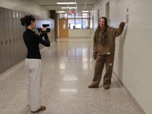 Smiling, sophomores Madi Rodhe and Emma Roberts film a video. On Jan. 8, the video one class filmed videos for a project.  