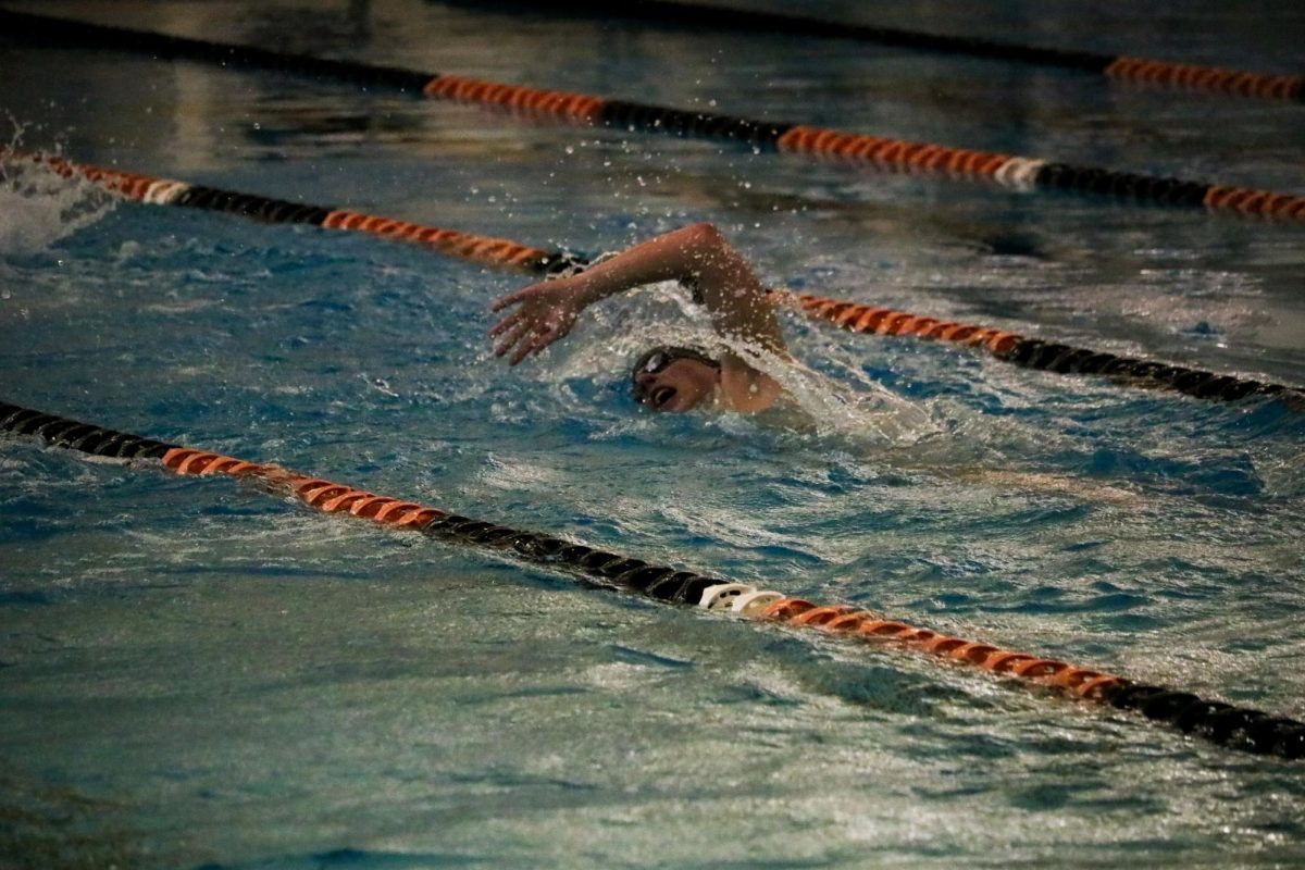 Swimming, junior Nate Hartzell swims down his lane doing the freestyle stroke. On Jan. 6, the varsity boy's swim team practiced for their upcoming swim meet. 
