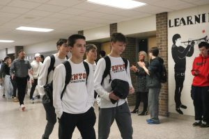 Walking, freshman Henry Golembieski and junior Aisen Velzy is getting clapped out by the school before they leaves for states. On Feb. 27, the wrestling team was applauded by Fenton High school for qualifying for states.