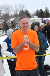 Shivering, teacher Todd Schroeder makes his way back to the Fenton Township building after jumping in the freezing cold waters of Lake Fenton. On Feb 1, members of the Fenton Area Public Schools staff participated in the annual Polar Plunge to raise money for Special Olympics of Michigan.