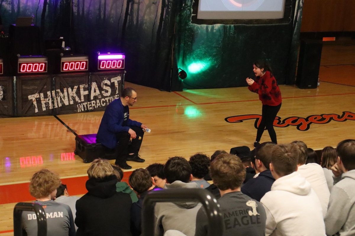 Yelling, sophomore Payton Conroy acts out a distracted driving skit. On March 25, sophomores and juniors attended the Thinkfast Interactive assembly during SRT. 