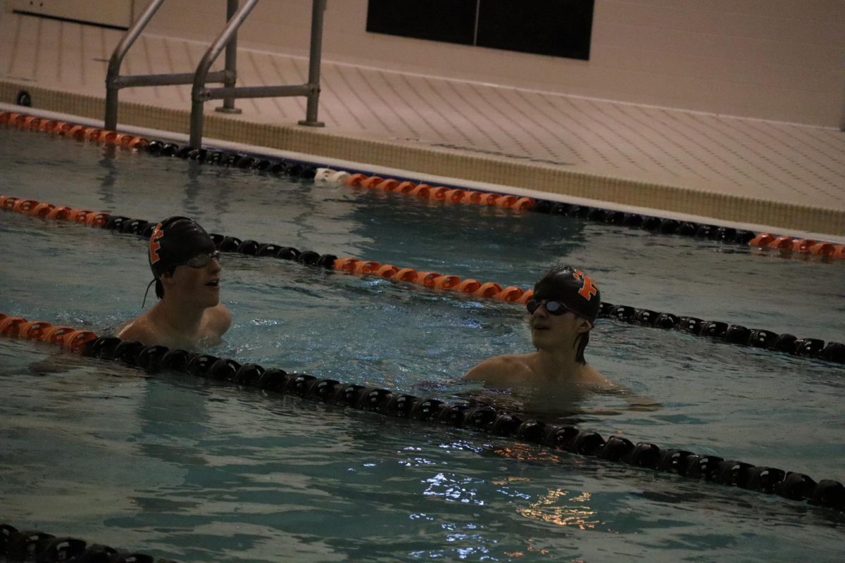Swimming down, sophomore Lucas Raby completes his set. On Feb 11, the FHS boys varsity swim team competed against Powers Catholic.  