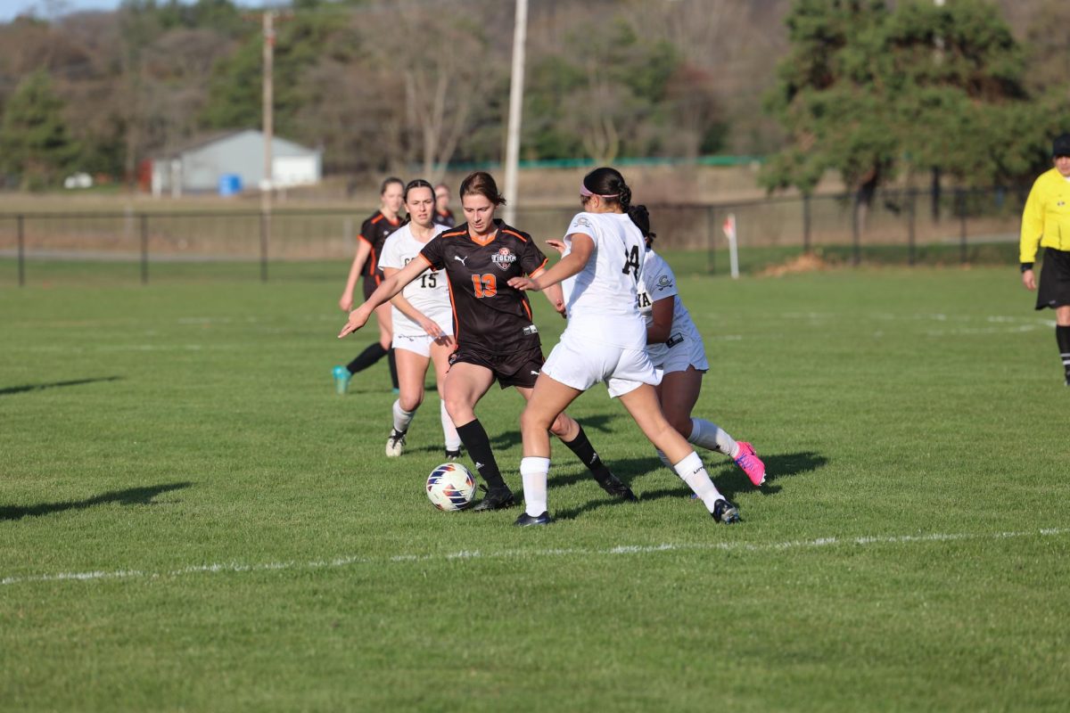 Defending, senior Maddie Sheffield guards her opponent from getting the ball. on April. 14, the varsity Fenton girls soccer team played Corunna and won 8-0.