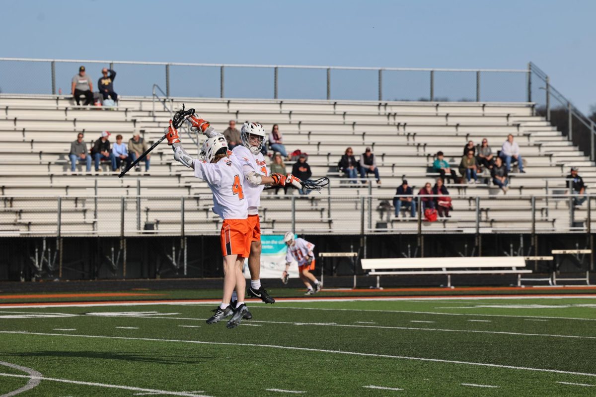 Celebrating, senior Owen Mueller and junior Nate Roberts both score 3 goals each for a win of 14-2. On April 22, the Fenton Lacrosse team beat Swartz Creek. 