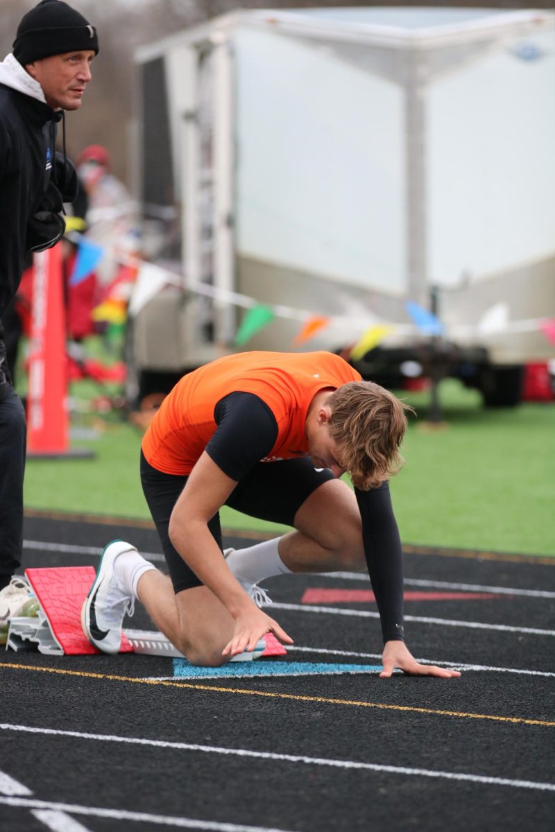 Setting up in his blocks, senior Cooper Steeves prepares to run the open 400 meter. On April 15, Fenton ran against Flushing and Holly in a tri-county meet. 