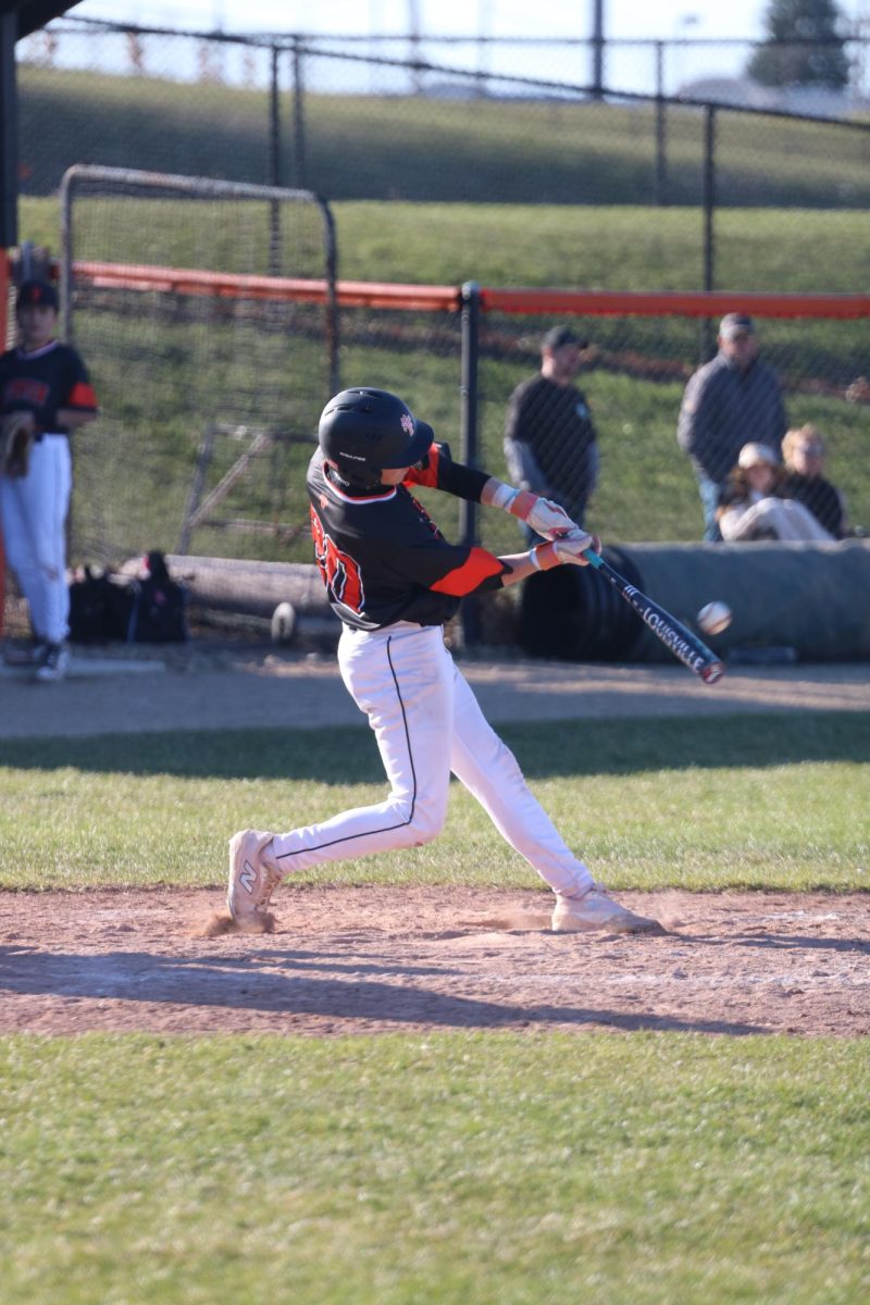 Batting, sophomore Noah Durling hits the ball. On Apr. 16, the JV Black baseball team played Holly and won. 