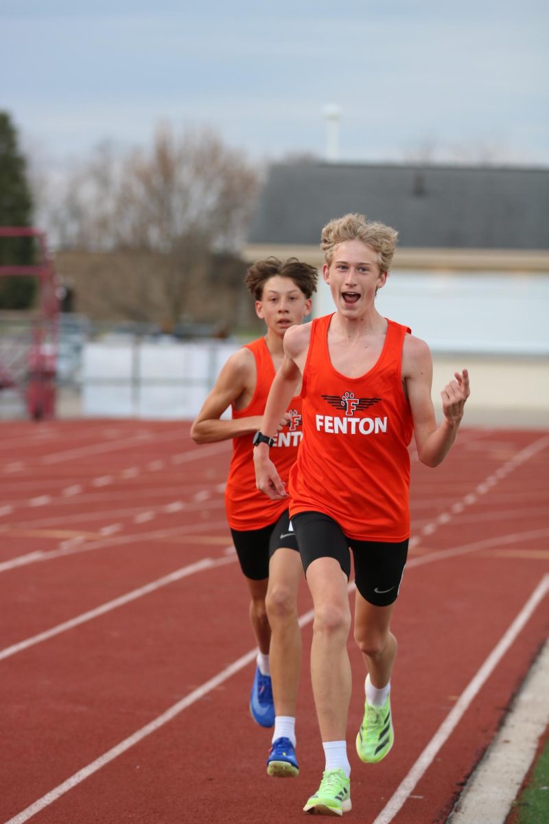 Celebrating, freshman Gavin Katic runs the mile. On April 22, Fenton went up against Linden and won. 