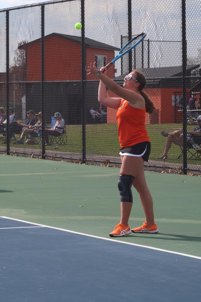 Swinging, senior Ruby Wojtaszek looks at the ball. On April 24, the FHS girls' varsity tennis team played against Owosso High School.