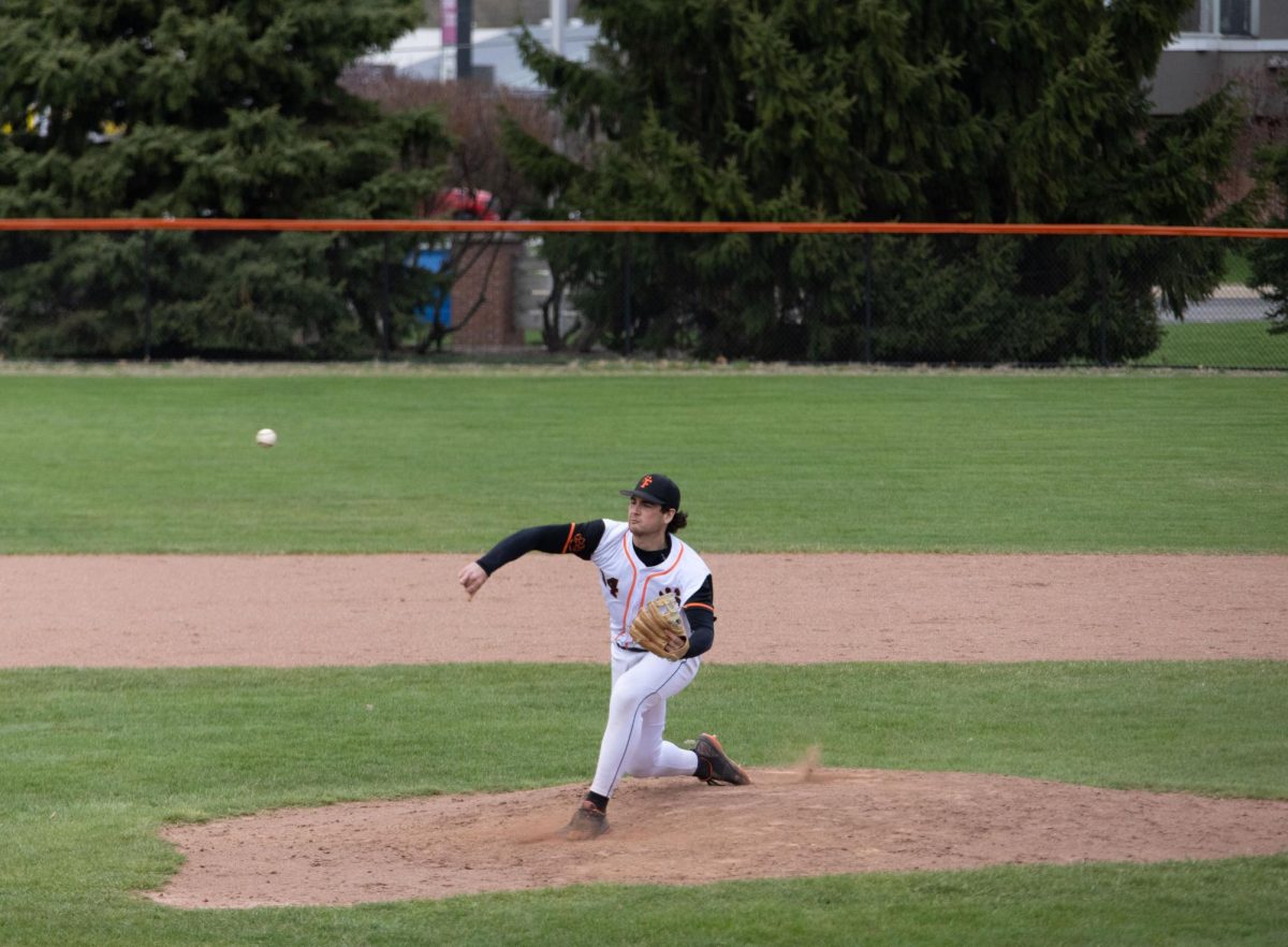 Pitching, senior Jadon Burnau throws the ball. On April 21, Fenton went head-to-head with Kearsley High, losing the game.