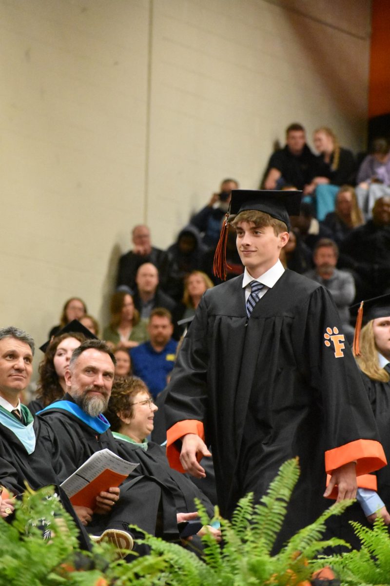 Walking, senior Ethan Brzezinksi graduates from FHS. On May 22, FHS held graduation in the gym. 