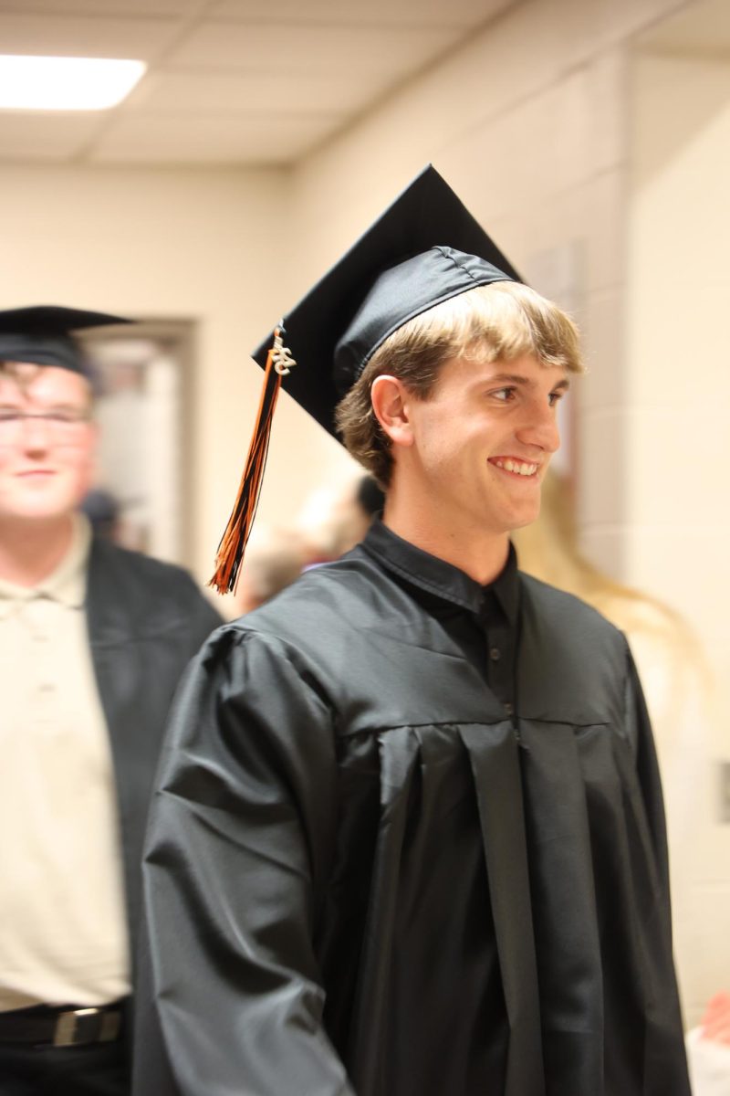 Smiling, senior Connor Mcdermott walks through the State Road senior clap out. On May 21, graduating seniors walked through their elementary schools. 