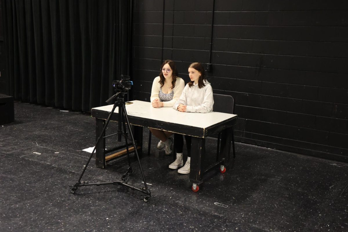 Speaking, sophomores Madi Rohde and Norah Stickle record a video. On May 23, students in the Thespian Troupe created ad campaigns. 
