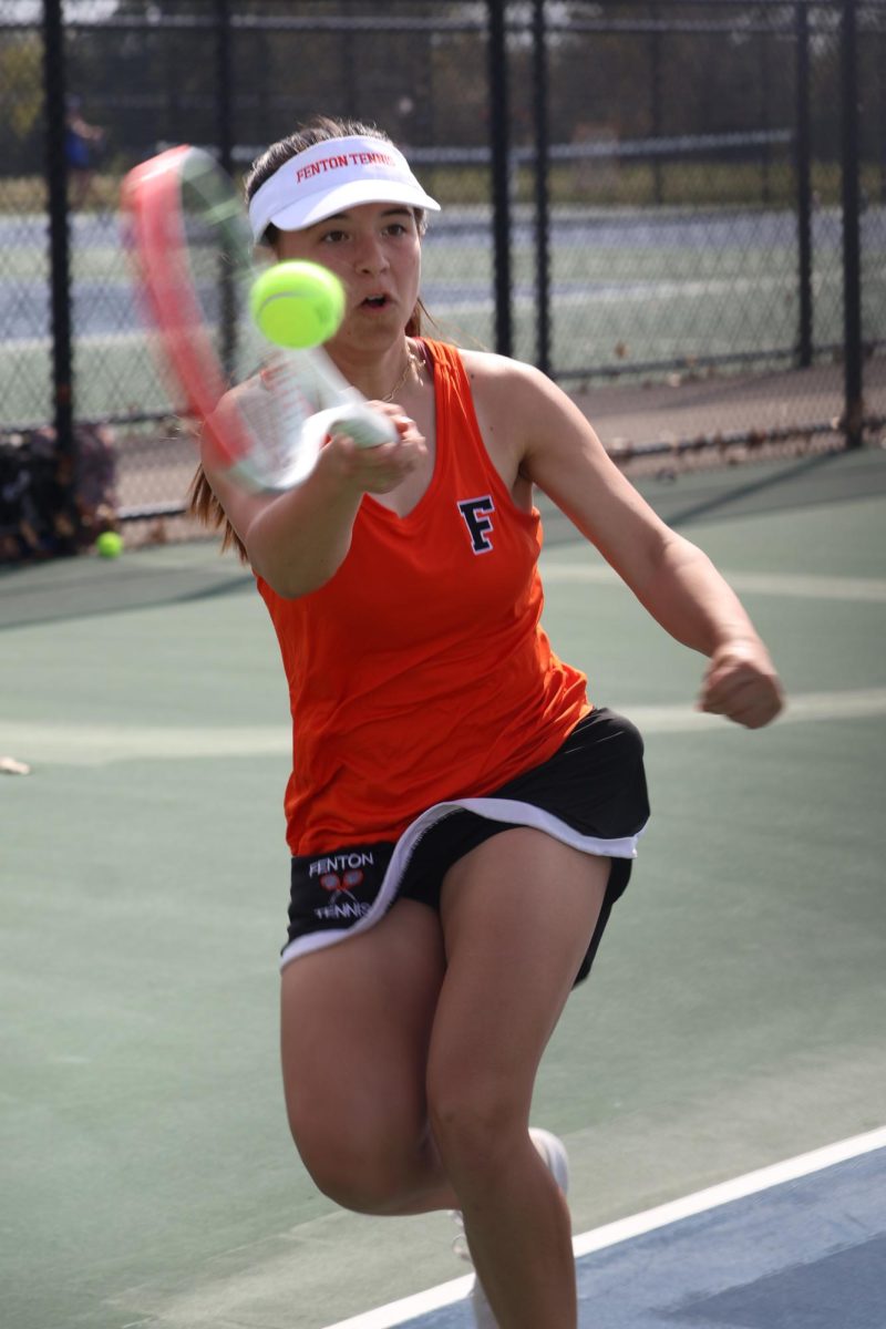 Playing, junior Isabel Bhagat looks at the ball. On May 7, the FHS girls varsity tennis team went up against Brandon High.