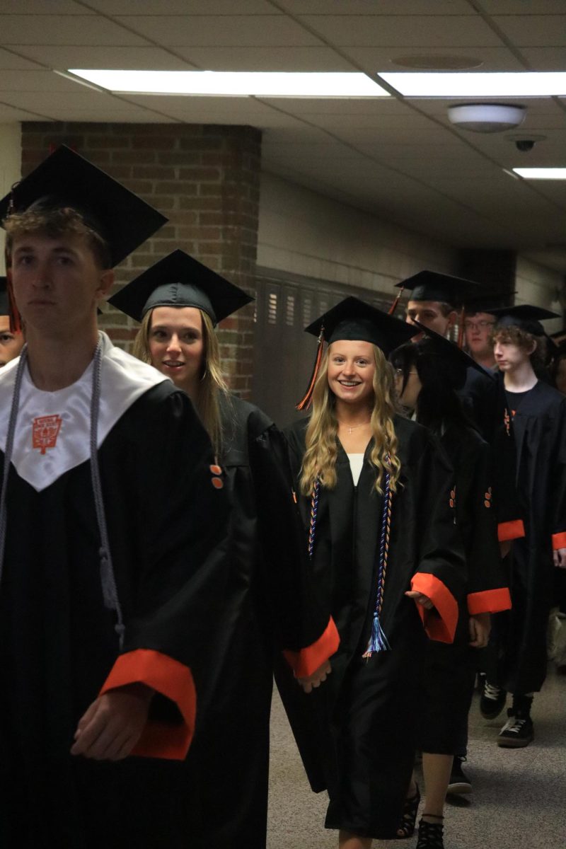 Smiling, senior Izzy MacCaughan participates in the senior clap out. On May 21, FHS seniors lead a parade to the honors assembly. 