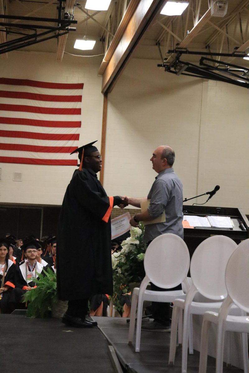 Shaking hands, senior Donnell Hall accepts the theater award. On May 21, an honors assembly was held in the gym for the graduating class of 2025. 
