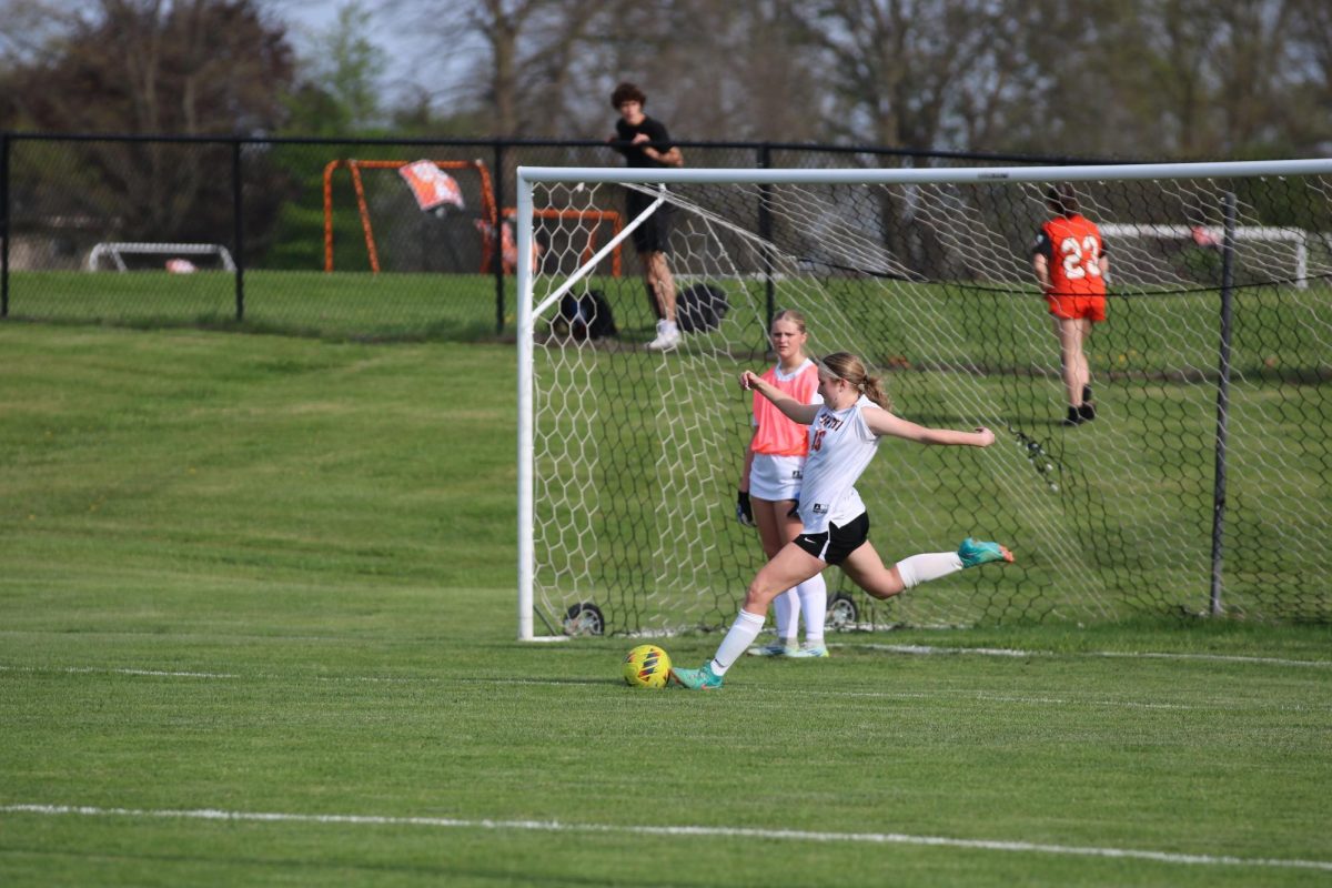 Kicking, freshman Natalie Mynatt goes to kick the ball. On May 7, the JV girls soccer team had a game against Flushing High.