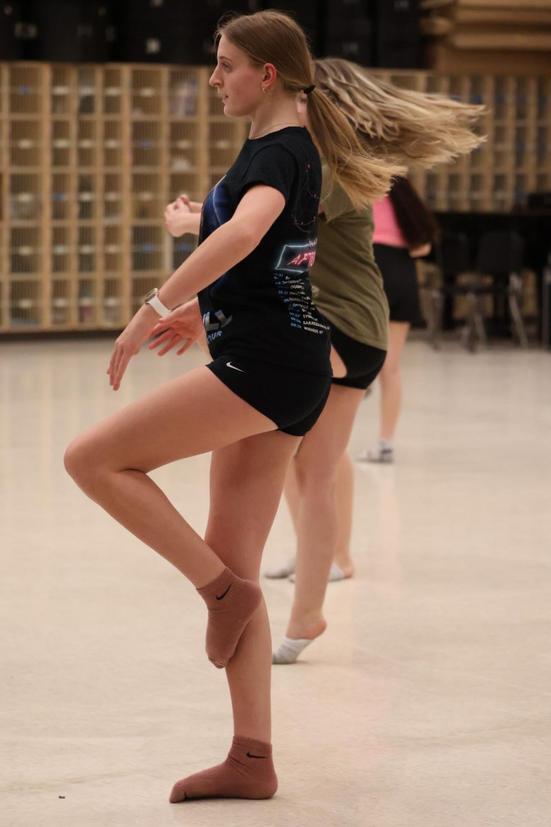 Practicing, freshmen Ava Holmes spins. On May 21, the FHS color guard ran through their show.