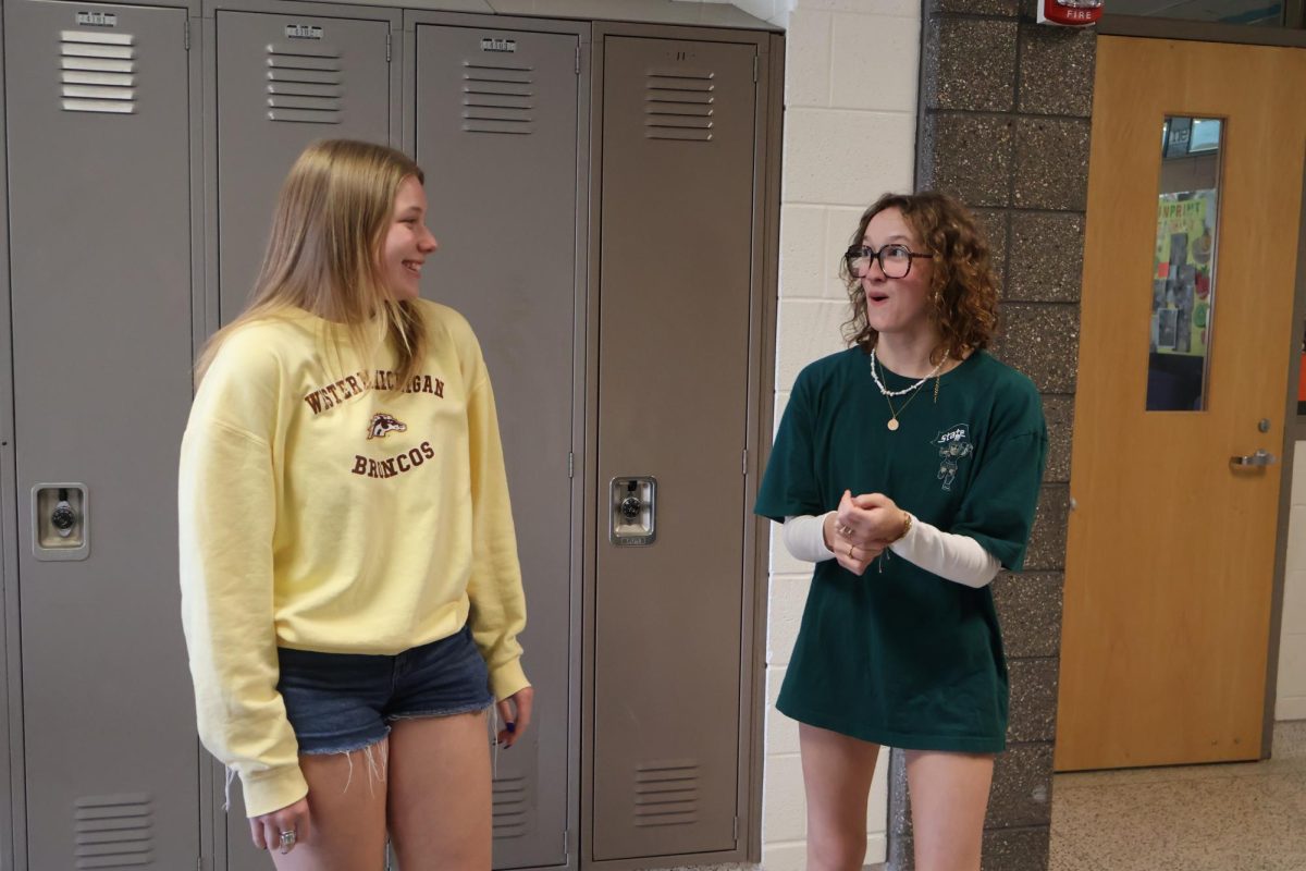Laughing, senior Jensen O'Brien and senior Remy stand in the hallway. On May 1, FHS seniors had college decision day.