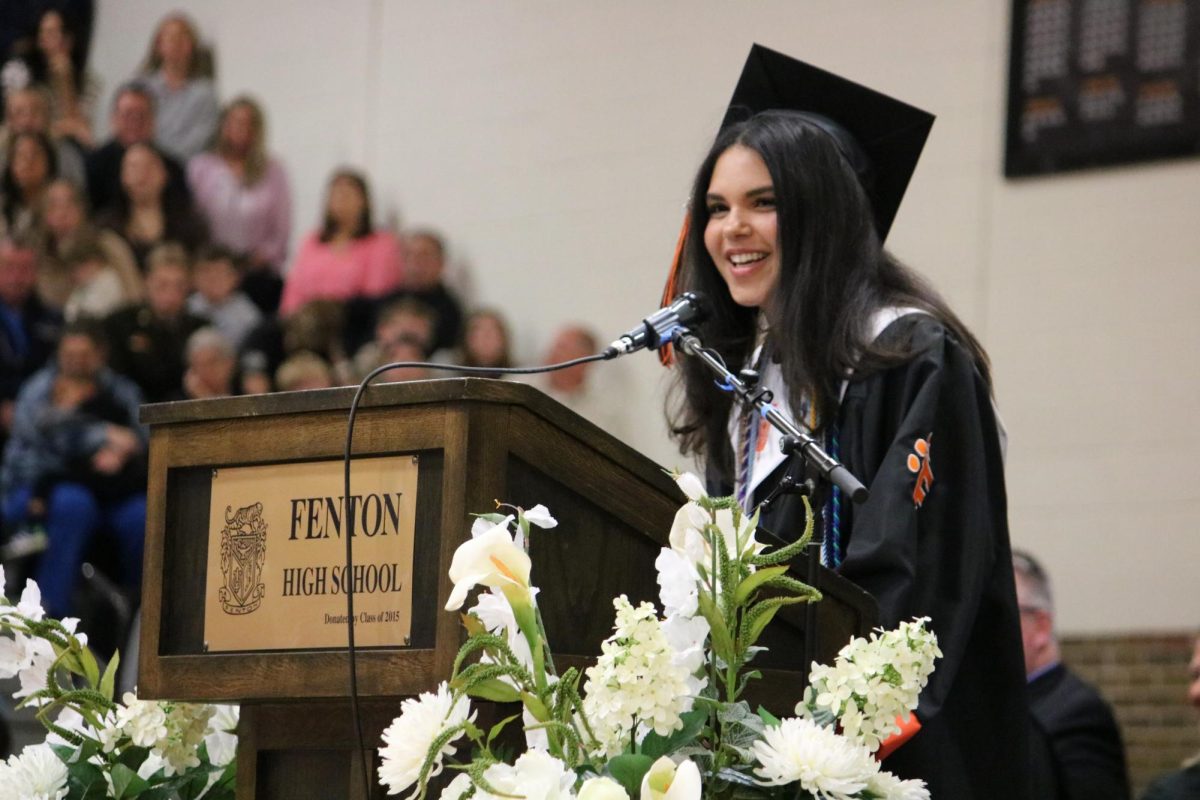 Speaking, senior Sophia Kildee converses with her class. On May 22, the class of 2025 met in the gym for graduation.