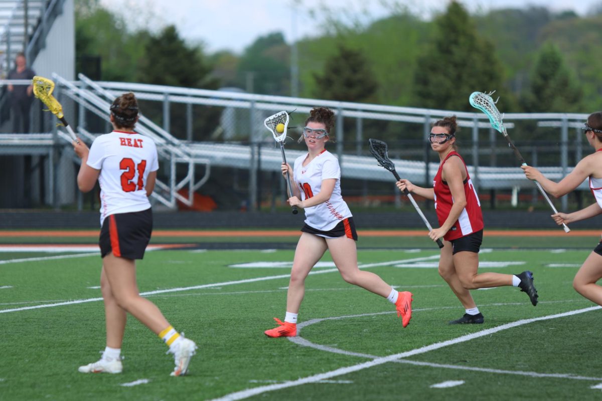 Passing, sophomore Jessie Livingston winds up to pass to her teammate. On May 14, the Heat lacrosse team lost 11-2.