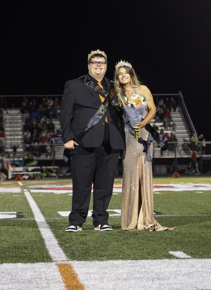 Posing for the camera, seniors Hunter Sayer and Eviana Fulton win Homecoming King and Queen. On Sept. 19, the Homecoming Court winners were announced at the football game. 
