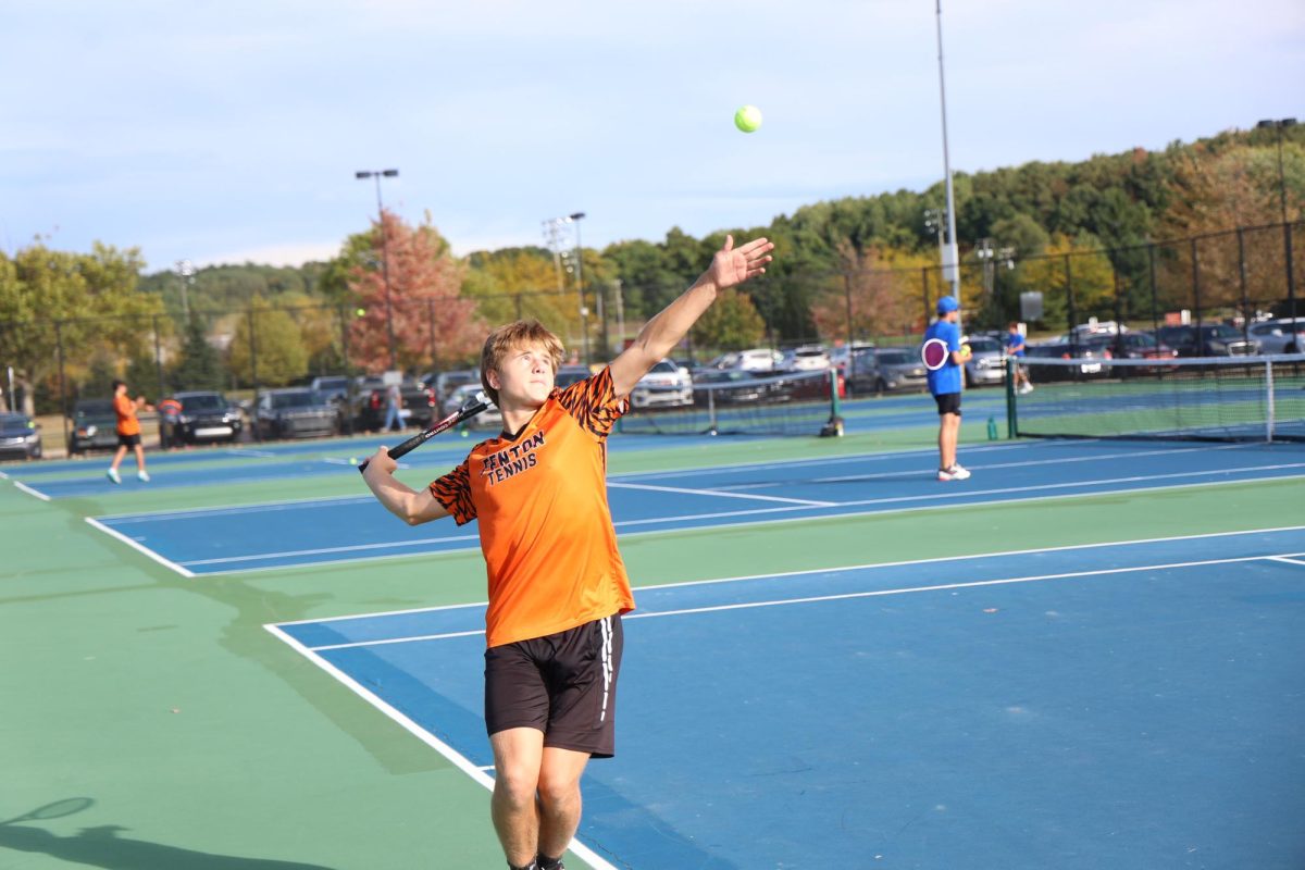Serving the ball  junior Devin Mays is playing Tennis against Goodrich. On sept. 23 Fenton played against goodrich.